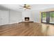 Spacious living room featuring a unique stone fireplace and sleek wood flooring at 1562 Oakhurst Dr, Brooksville, FL 34601