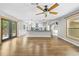 Bright open-concept living space featuring wood floors and a modern kitchen at 1562 Oakhurst Dr, Brooksville, FL 34601