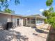 Exterior view of a backyard featuring a brick patio and screened in porch at 1701 38Th N St, St Petersburg, FL 33713