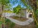 Landscaped backyard featuring a brick walkway with lush, tropical vegetation at 1701 38Th N St, St Petersburg, FL 33713