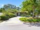 Charming home with a circular driveway framed by mature trees and manicured landscaping at 1701 38Th N St, St Petersburg, FL 33713