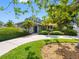 Charming home with a well-manicured lawn, mature trees, and a curved driveway at 1701 38Th N St, St Petersburg, FL 33713