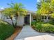 Inviting single-story home with lush landscaping, palm trees, and a neatly maintained front yard at 1701 38Th N St, St Petersburg, FL 33713