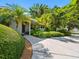 A home exterior featuring manicured bushes and palms, enhanced by a welcoming walkway at 1701 38Th N St, St Petersburg, FL 33713