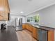 Modern kitchen with stainless steel appliances, wood cabinetry, and a bright window above the sink at 1701 38Th N St, St Petersburg, FL 33713