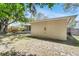Back exterior shows the house and backyard at 1739 Woodridge Dr, Clearwater, FL 33756