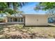 Back exterior shows backyard and enclosed sunroom at 1739 Woodridge Dr, Clearwater, FL 33756