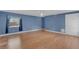Bedroom with wood laminate flooring, neutral paint, and a window overlooking front yard at 1739 Woodridge Dr, Clearwater, FL 33756