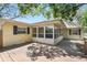 Back exterior features wooden deck and an enclosed sunroom at 1739 Woodridge Dr, Clearwater, FL 33756