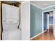 Hallway with stacked washer/dryer and fresh paint at 1739 Woodridge Dr, Clearwater, FL 33756