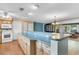 Bright kitchen showcasing a breakfast bar, white appliances, and laminate flooring with blue accents at 1739 Woodridge Dr, Clearwater, FL 33756