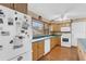 Bright kitchen with wood floors and cabinets, modern appliances, and natural light streaming through the window at 1739 Woodridge Dr, Clearwater, FL 33756