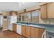 Well-lit kitchen featuring stainless steel sink, appliances, wood cabinets, and a window with natural light at 1739 Woodridge Dr, Clearwater, FL 33756