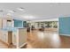 Open-concept living area features a spacious layout with hardwood floors and natural light from large windows at 1739 Woodridge Dr, Clearwater, FL 33756