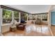 Sun-lit sun room featuring hardwood floors and multiple large windows offering views of backyard at 1739 Woodridge Dr, Clearwater, FL 33756