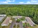 Aerial view of homes in a wooded area, showcasing the community's serene and natural surroundings at 1762 Atrium Dr, Sun City Center, FL 33573