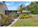 Lush backyard featuring a well-maintained lawn and mature landscaping at 1762 Atrium Dr, Sun City Center, FL 33573