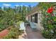 Private backyard featuring a pair of lounge chairs and blooming hibiscus, creating a serene and inviting outdoor space at 1762 Atrium Dr, Sun City Center, FL 33573
