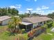 Aerial view of a home with a large yard, screen lanai, and mature landscaping; perfect for enjoying the outdoors at 1762 Atrium Dr, Sun City Center, FL 33573