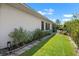 Lush backyard with a well-manicured lawn, mature plants, and outdoor seating area, perfect for relaxing and enjoying the outdoors at 1762 Atrium Dr, Sun City Center, FL 33573