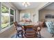 Bright dining area with tiled floor, glass table and large windows at 1762 Atrium Dr, Sun City Center, FL 33573