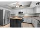 Bright kitchen featuring white cabinets, stainless steel appliances, and center island at 1762 Atrium Dr, Sun City Center, FL 33573