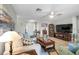Inviting living room with a neutral color palette, tile floors, and cozy furniture at 1762 Atrium Dr, Sun City Center, FL 33573
