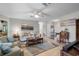 Comfortable living room featuring tile flooring, a ceiling fan, and lots of natural light at 1762 Atrium Dr, Sun City Center, FL 33573