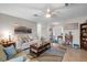 Bright living room features tile floors, comfortable furnishings, and a ceiling fan at 1762 Atrium Dr, Sun City Center, FL 33573