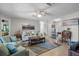 Cozy living room with neutral walls, tile floors, comfortable seating, and stylish decor at 1762 Atrium Dr, Sun City Center, FL 33573