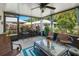 Enclosed sunroom featuring comfortable seating and views of the landscaped backyard at 1762 Atrium Dr, Sun City Center, FL 33573