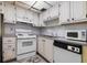 Functional kitchen with ample cabinet space and standard appliances at 1802 Bedford Ln # 7, Sun City Center, FL 33573