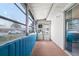 Enclosed sunroom with blue paneled walls and many windows at 1802 Bedford Ln # 7, Sun City Center, FL 33573