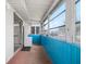 Enclosed sunroom with blue paneled walls and many windows at 1802 Bedford Ln # 7, Sun City Center, FL 33573