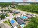 Aerial view featuring homes, a clubhouse, Charles S. Rushe Middle School, and Sunlake High School at 18516 Snowdonia Dr, Land O Lakes, FL 34638