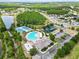 Community aerial view showing the clubhouse, pool, playground, tennis courts, and surrounding residential area at 18516 Snowdonia Dr, Land O Lakes, FL 34638