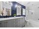 Modern bathroom with double vanity, granite countertops, and walk-in shower with white subway tile at 18516 Snowdonia Dr, Land O Lakes, FL 34638