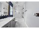Bathroom features a tub and shower combination, modern sink, and decorative patterned tile flooring at 18516 Snowdonia Dr, Land O Lakes, FL 34638