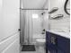 Bathroom includes a vanity and sink with modern fixtures, shower with subway tile, and modern shelving at 18516 Snowdonia Dr, Land O Lakes, FL 34638