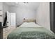Bedroom features a ceiling fan, television, desk and white and black decor at 18516 Snowdonia Dr, Land O Lakes, FL 34638
