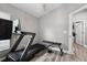 Exercise room featuring natural lighting, workout equipment, and wooden vinyl flooring at 18516 Snowdonia Dr, Land O Lakes, FL 34638