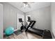Exercise room features exercise equipment, ceiling fan, and a large window with natural light at 18516 Snowdonia Dr, Land O Lakes, FL 34638