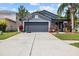 Charming single-story home with a well-manicured lawn, inviting entrance, and basketball hoop at 18516 Snowdonia Dr, Land O Lakes, FL 34638