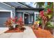 Inviting home entrance with colorful landscaping and a welcoming front porch sign at 18516 Snowdonia Dr, Land O Lakes, FL 34638