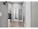 Hallway leads to rooms with exercise equipment, bathroom with shower, and bedrooms with white doors at 18516 Snowdonia Dr, Land O Lakes, FL 34638