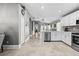 Modern kitchen with stainless steel appliances, white cabinets, and a stylish open floor plan at 18516 Snowdonia Dr, Land O Lakes, FL 34638