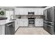Bright, functional kitchen with stainless steel appliances and sleek white cabinets at 18516 Snowdonia Dr, Land O Lakes, FL 34638