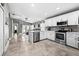 Open-concept kitchen featuring a center island, stainless steel appliances, and neutral toned cabinets at 18516 Snowdonia Dr, Land O Lakes, FL 34638