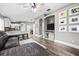 Bright, open living space featuring a gray sectional sofa, modern furnishings and hardwood flooring at 18516 Snowdonia Dr, Land O Lakes, FL 34638