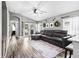 Comfortable living room with a large sectional sofa, ceiling fan, and access to the backyard at 18516 Snowdonia Dr, Land O Lakes, FL 34638